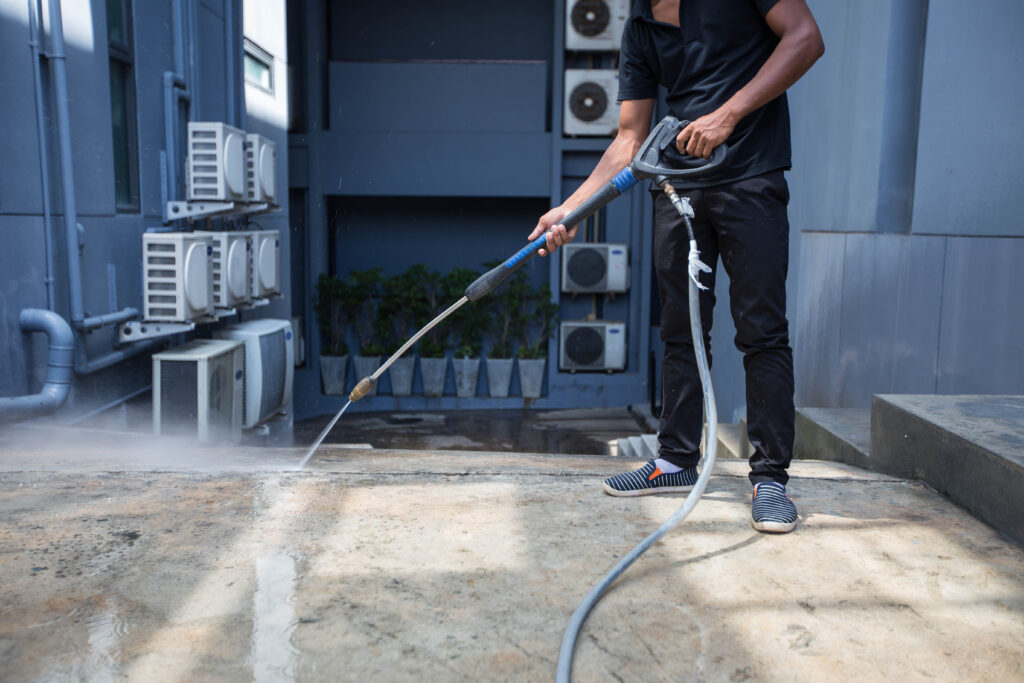 The man cleaning with high pressure water jet.