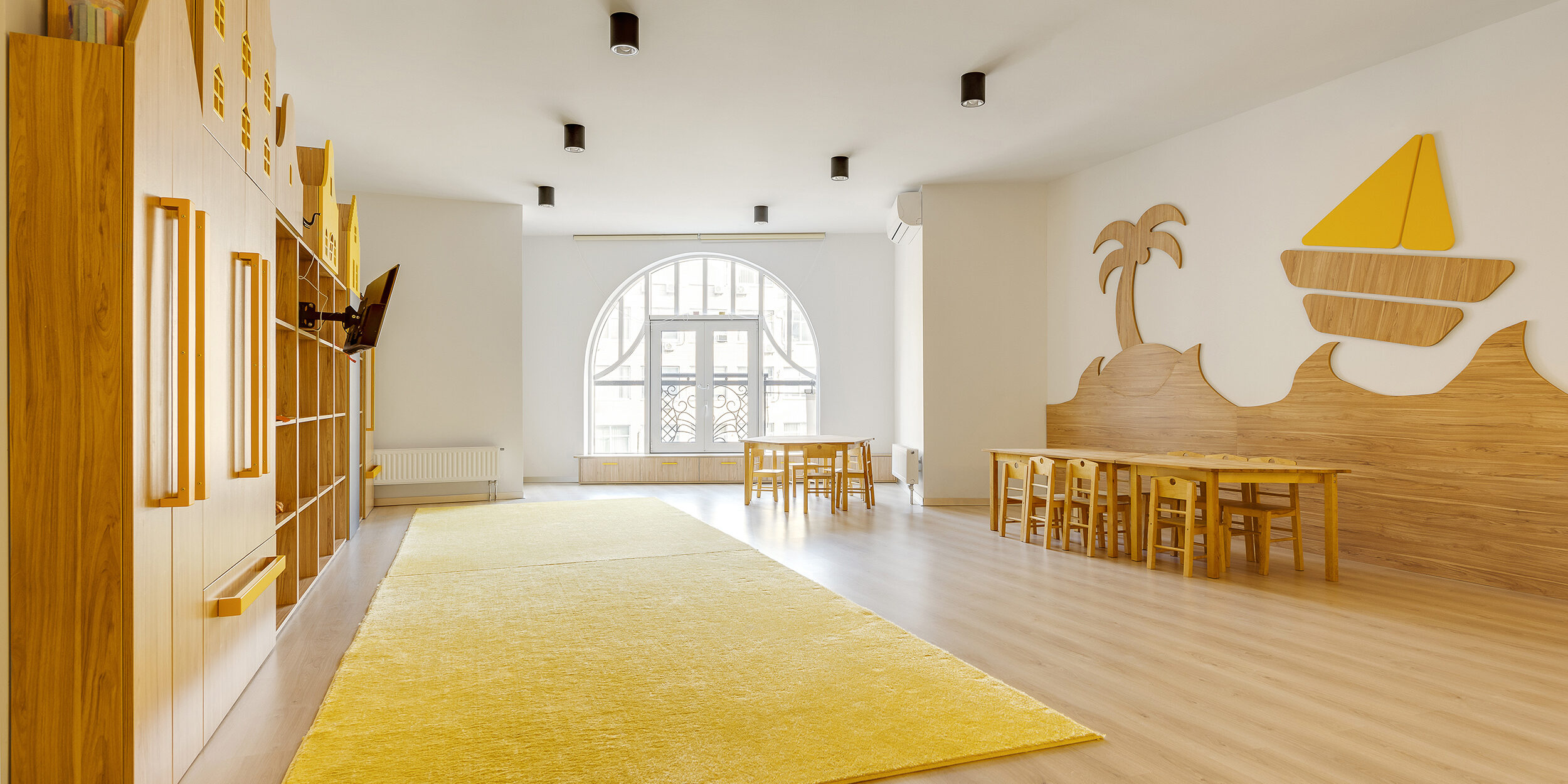 cozy light classroom with wooden furniture in modern kindergarten